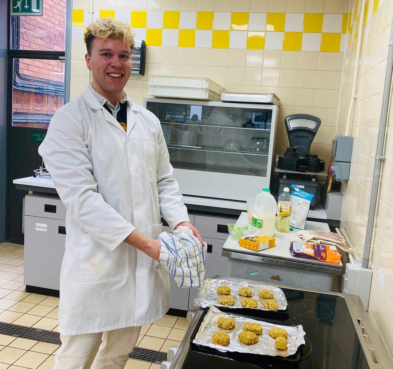 Ben demonstrating protein research with a domestic oven in a lab.